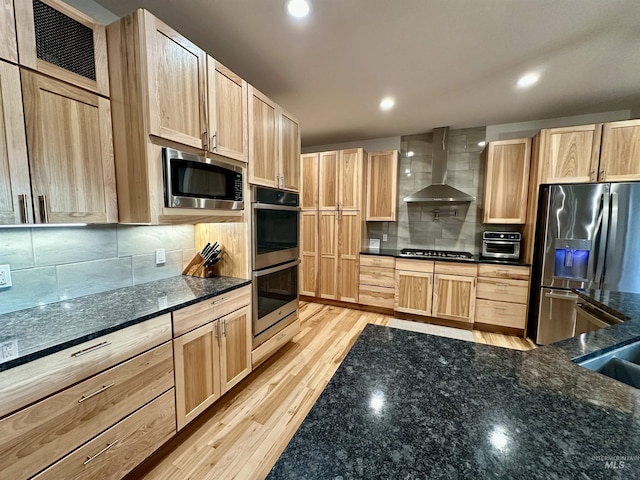 1321 Lande Ln, Moscow, ID 83843 - kitchen featuring light wood-style flooring, light brown cabinetry, appliances with stainless steel finishes, wall chimney exhaust hood, and backsplash