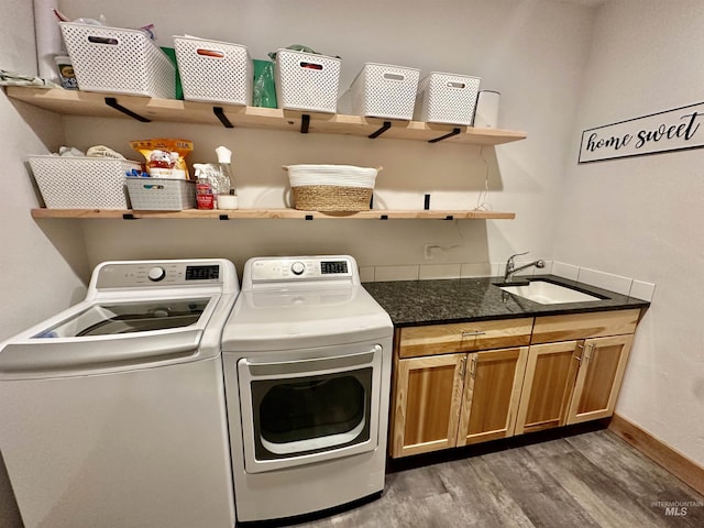 1321 Lande Ln, Moscow, ID 83843 - washroom with baseboards, light wood-style flooring, cabinet space, a sink, and washer and clothes dryer