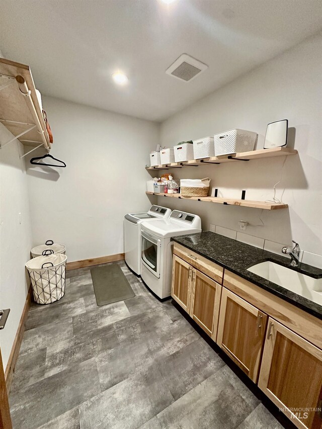 1321 Lande Ln, Moscow, ID 83843 - laundry room with a sink, cabinet space, baseboards, and washer and clothes dryer