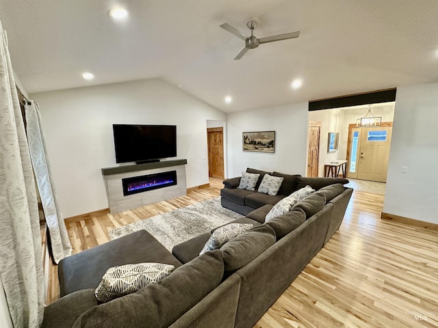 1321 Lande Ln, Moscow, ID 83843 - living area with a glass covered fireplace, light wood-style floors, baseboards, ceiling fan, and vaulted ceiling