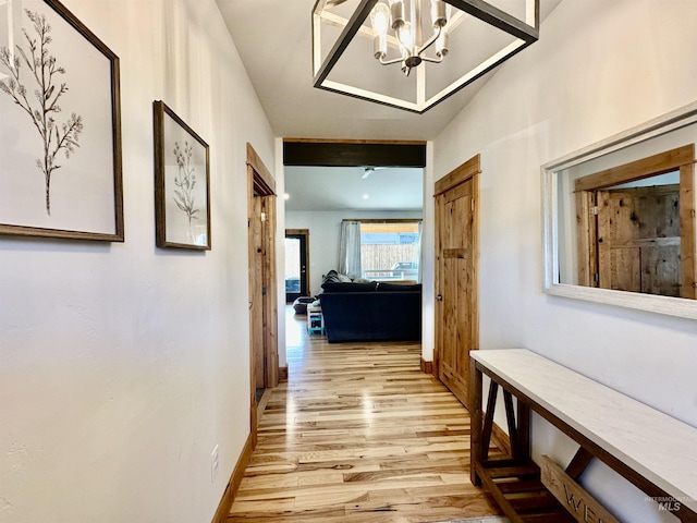 1321 Lande Ln, Moscow, ID 83843 - hallway with a notable chandelier, baseboards, and light wood-style floors