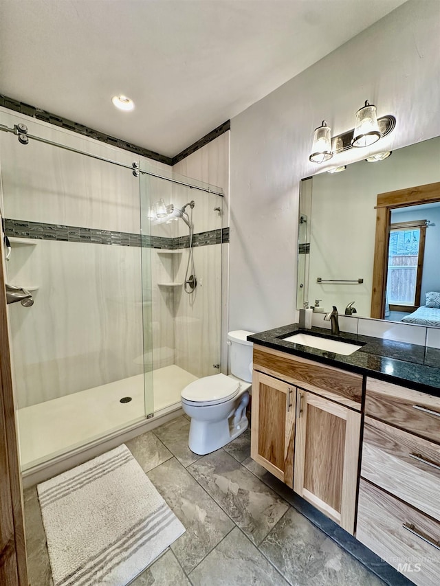 1321 Lande Ln, Moscow, ID 83843 - full bathroom with vanity, a shower stall, and toilet