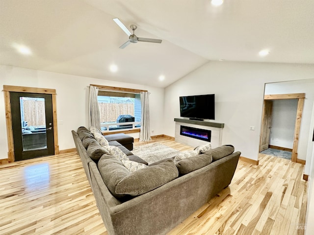 1321 Lande Ln, Moscow, ID 83843 - living area with a glass covered fireplace, light wood-type flooring, lofted ceiling, and ceiling fan