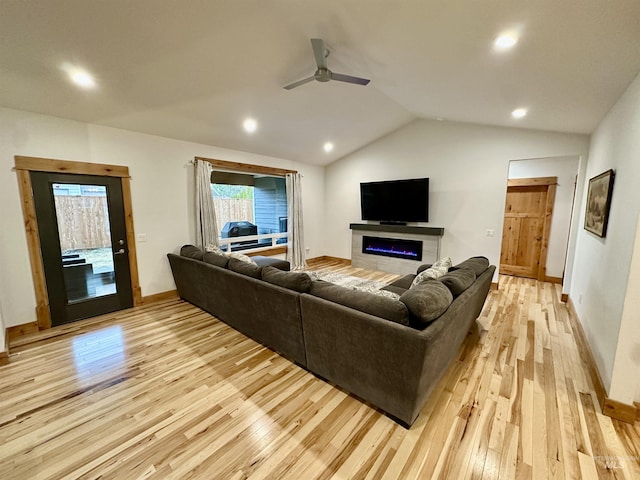 1321 Lande Ln, Moscow, ID 83843 - living area featuring light wood finished floors, a glass covered fireplace, a ceiling fan, and vaulted ceiling
