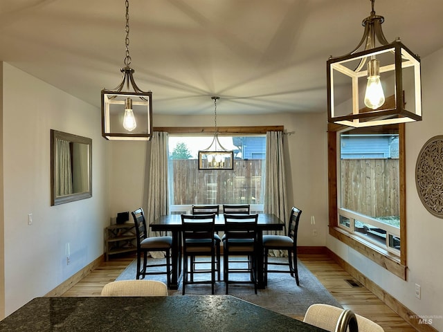 1321 Lande Ln, Moscow, ID 83843 - dining space with visible vents, baseboards, wood finished floors, and a chandelier