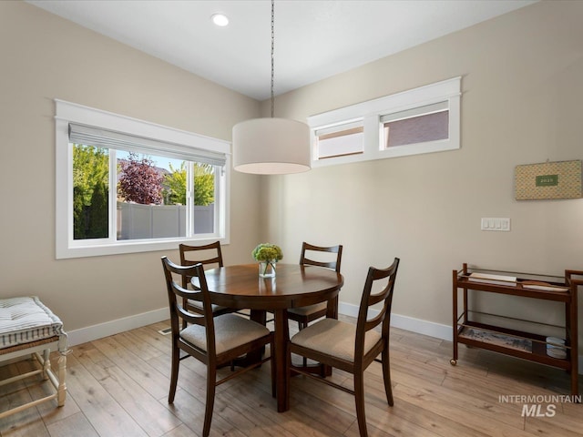 dining area with baseboards, recessed lighting, and light wood-type flooring