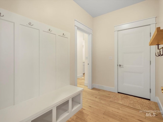 mudroom with baseboards and light wood finished floors