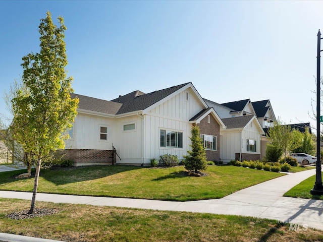 view of front facade featuring board and batten siding and a front lawn