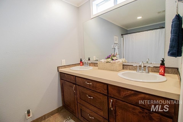 1627 Verdant Ct, Emmett, ID 83617 - full bath featuring double vanity, crown molding, tile patterned flooring, and baseboards
