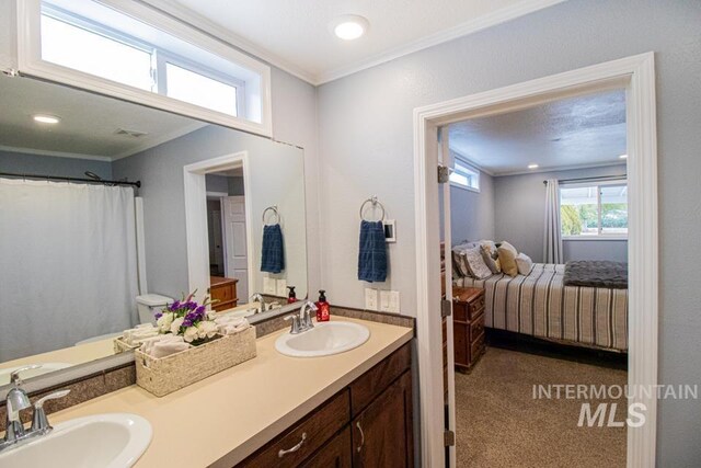 1627 Verdant Ct, Emmett, ID 83617 - bathroom featuring double vanity, ornamental molding, and ensuite bath