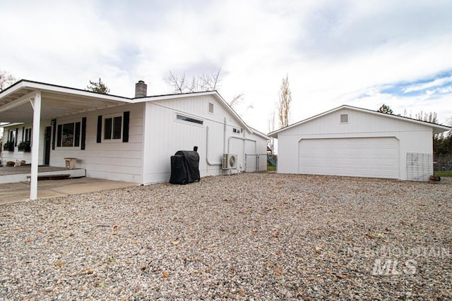 1627 Verdant Ct, Emmett, ID 83617 - view of home's exterior with a chimney, a cooling unit, a detached garage, and an outdoor structure