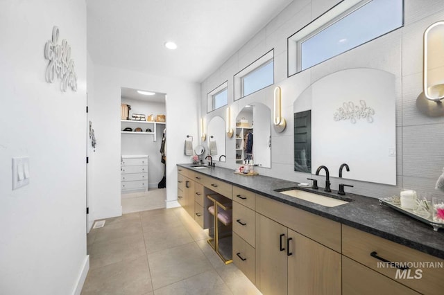 bathroom featuring tile patterned flooring, vanity, and plenty of natural light