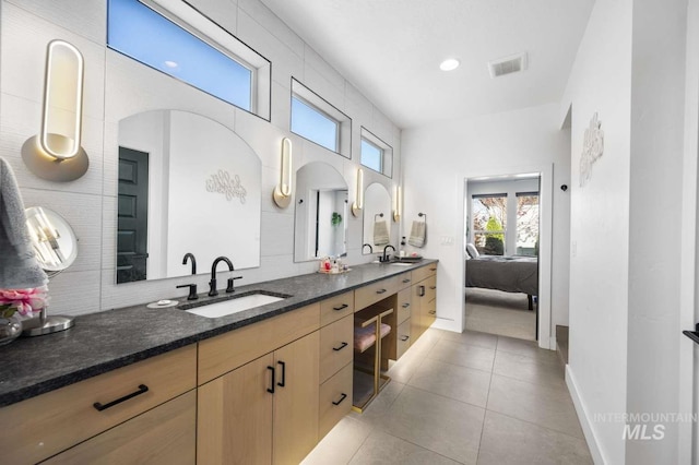 bathroom featuring tile patterned flooring and vanity