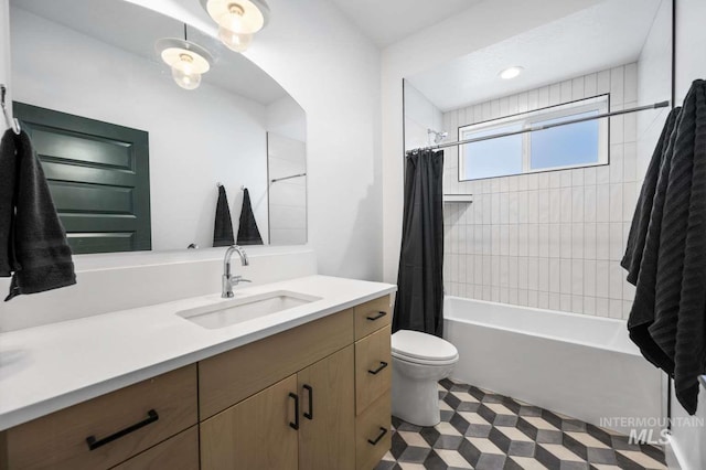 full bathroom featuring vanity, shower / tub combo, and toilet