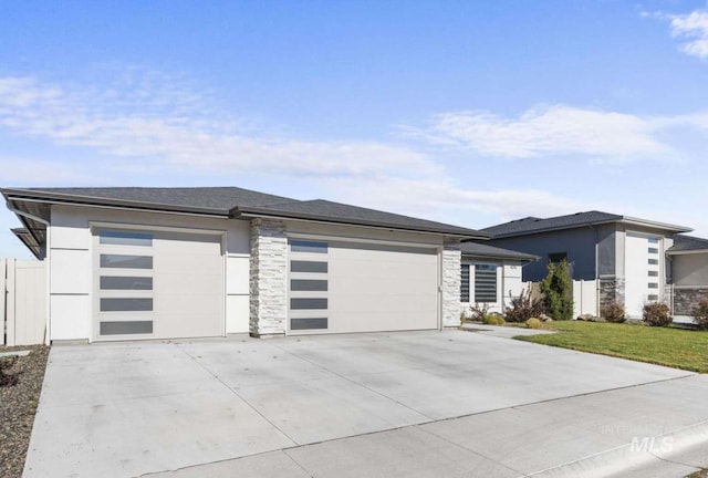 prairie-style house with a garage and a front lawn