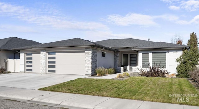 prairie-style home featuring a garage and a front lawn