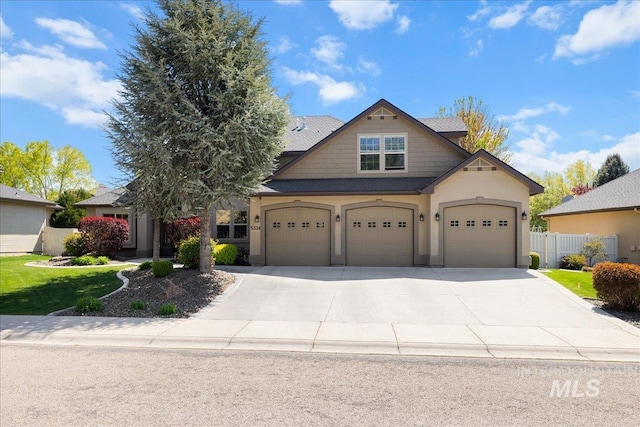 view of front facade with a garage, fence, stucco siding, and concrete driveway