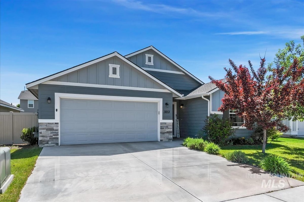 3853 W Farlam Dr, Meridian, ID 83642 - view of front of home featuring stone siding, an attached garage, concrete driveway, and board and batten siding