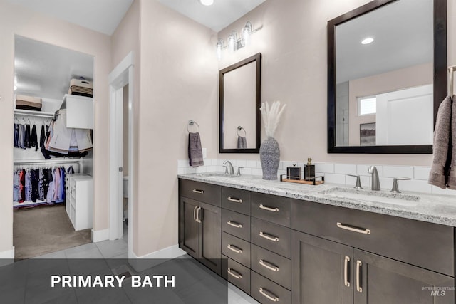 9478 W Napier St, Star, ID 83669 - full bath with double vanity, tile patterned flooring, a walk in closet, baseboards, and toilet