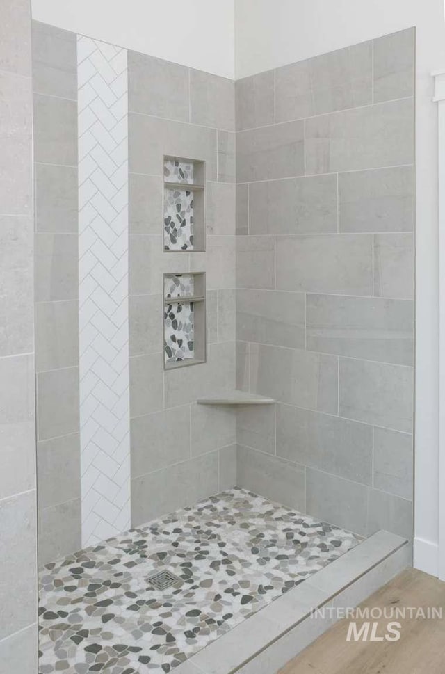 bathroom with tiled shower