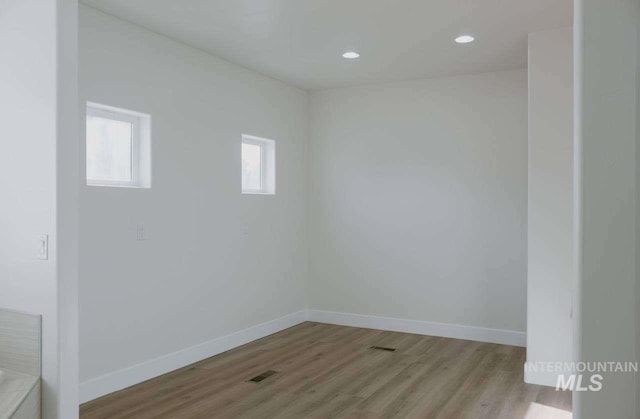 unfurnished room with light wood-type flooring