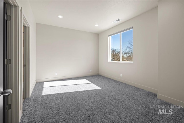 spare room with recessed lighting, carpet, visible vents, and baseboards