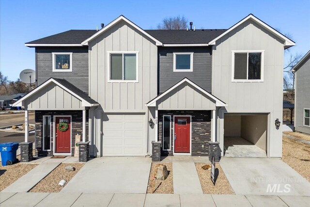 view of front of home featuring a garage, concrete driveway, board and batten siding, and roof with shingles