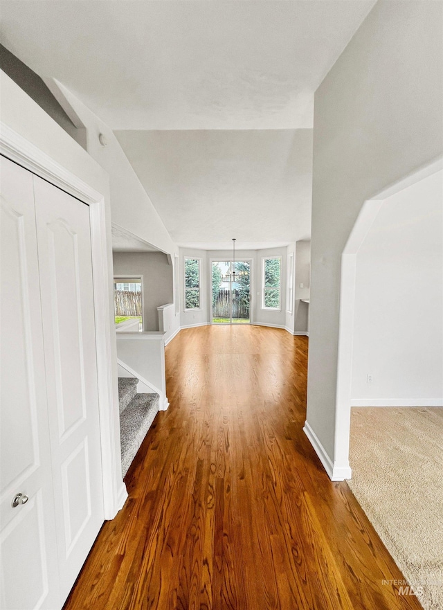 2506 S Culpeper Ave, Boise, ID 83709 - bonus room with baseboards, a chandelier, lofted ceiling, wood finished floors, and stairs