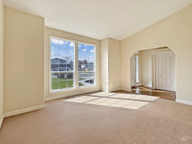 2506 S Culpeper Ave, Boise, ID 83709 - unfurnished room featuring arched walkways, baseboards, visible vents, and carpet