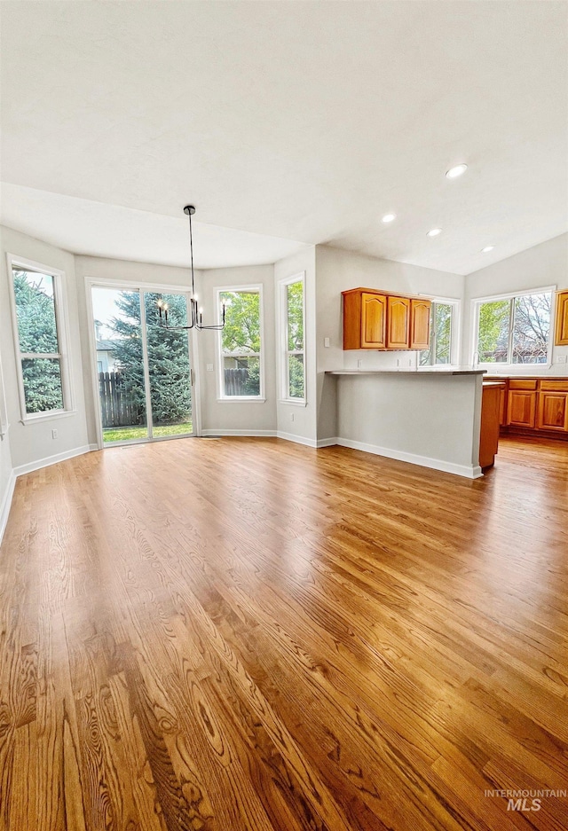 2506 S Culpeper Ave, Boise, ID 83709 - unfurnished living room with plenty of natural light, baseboards, and light wood-style floors