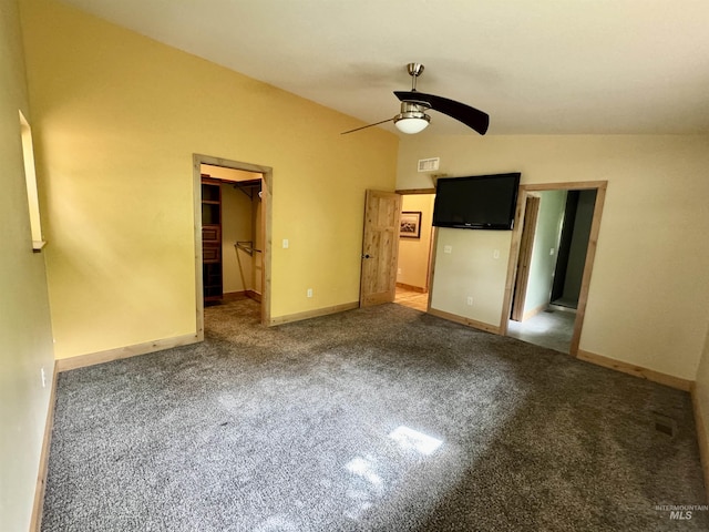 unfurnished bedroom featuring a walk in closet, carpet floors, a ceiling fan, baseboards, and visible vents