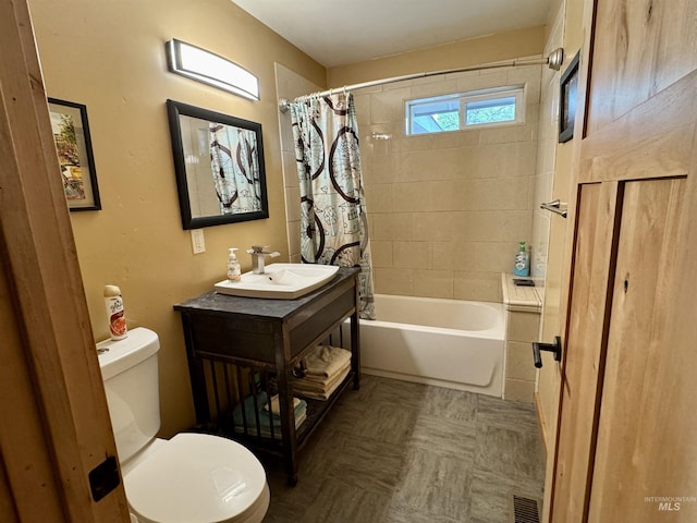full bath with toilet, visible vents, shower / bath combo, and vanity