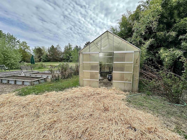 view of greenhouse featuring a garden