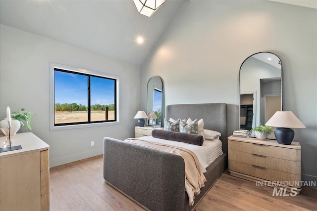 bedroom featuring baseboards, high vaulted ceiling, light wood-style floors, and recessed lighting