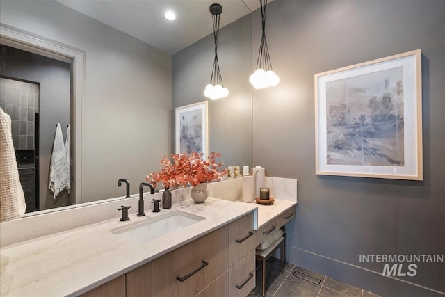 bathroom featuring baseboards, tile patterned flooring, and vanity