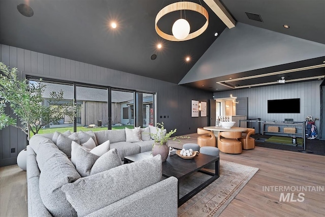 living room featuring visible vents, beam ceiling, recessed lighting, wood finished floors, and high vaulted ceiling