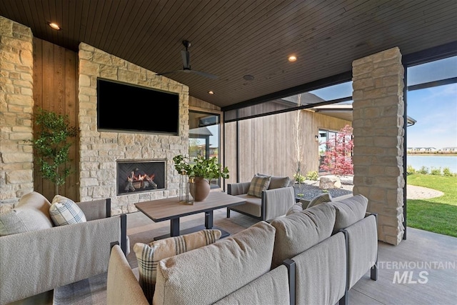 view of patio featuring an outdoor living space with a fireplace