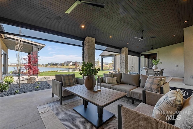 view of patio with an outdoor hangout area, a ceiling fan, and a water view