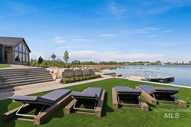 view of yard featuring a water view and a floating dock