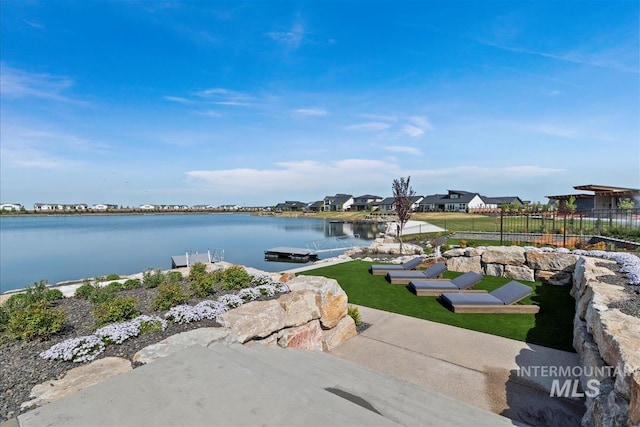 water view with a dock and fence