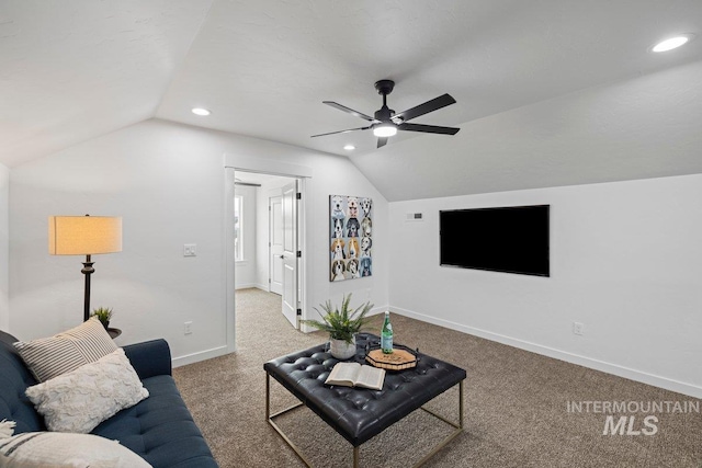 carpeted living room with ceiling fan and lofted ceiling