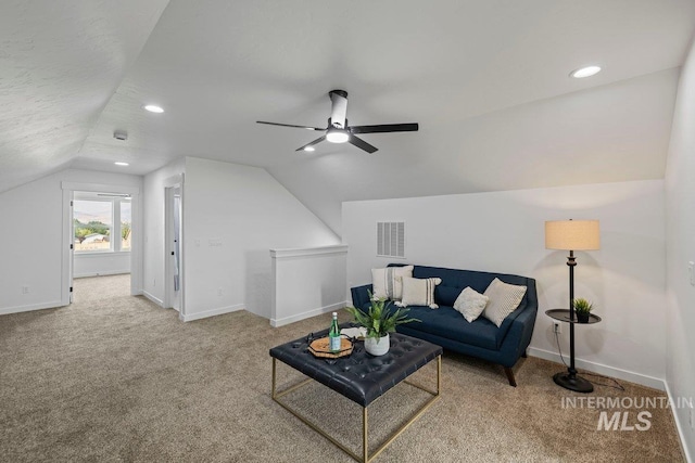 living room with carpet, ceiling fan, and lofted ceiling