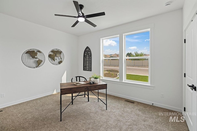 carpeted office space with a wealth of natural light and ceiling fan