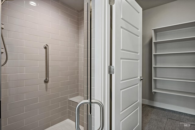 bathroom with a shower with shower door