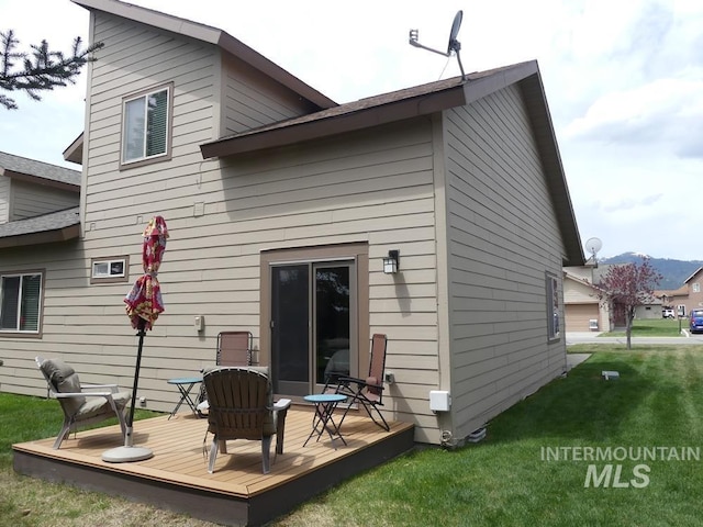 24 Mangum Dr Unit 1, Donnelly, ID 83615 - rear view of property with a deck and a lawn