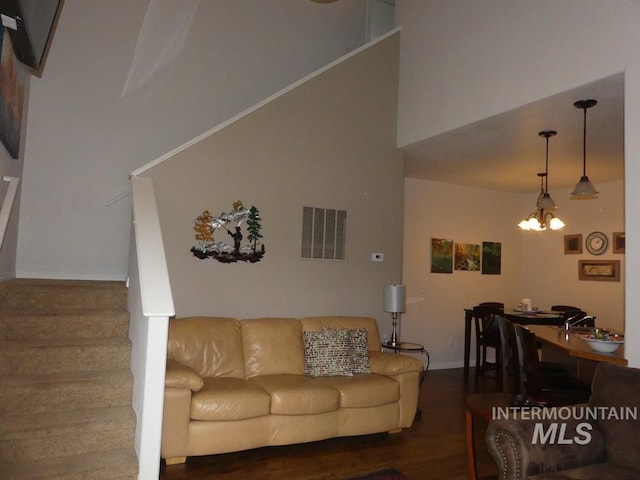 24 Mangum Dr Unit 1, Donnelly, ID 83615 - living room with wood finished floors, a chandelier, stairway, a towering ceiling, and baseboards