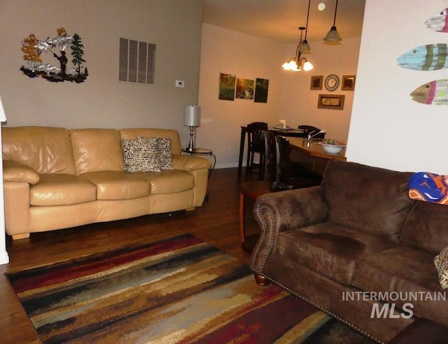 24 Mangum Dr Unit 1, Donnelly, ID 83615 - living room featuring wood finished floors, a chandelier, and baseboards