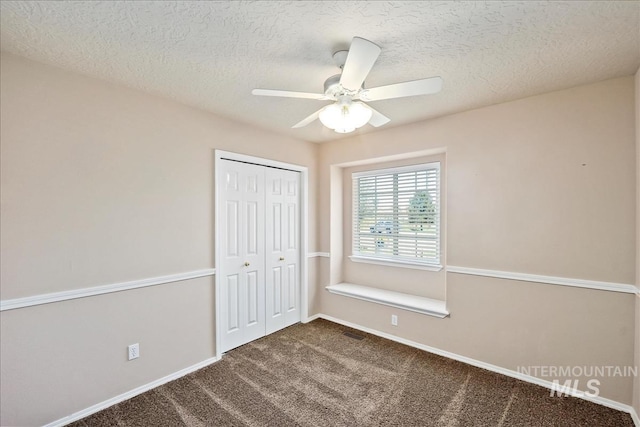 3804 Stonehedge Way, Caldwell, ID 83605 - unfurnished bedroom with dark carpet, a closet, a textured ceiling, and ceiling fan