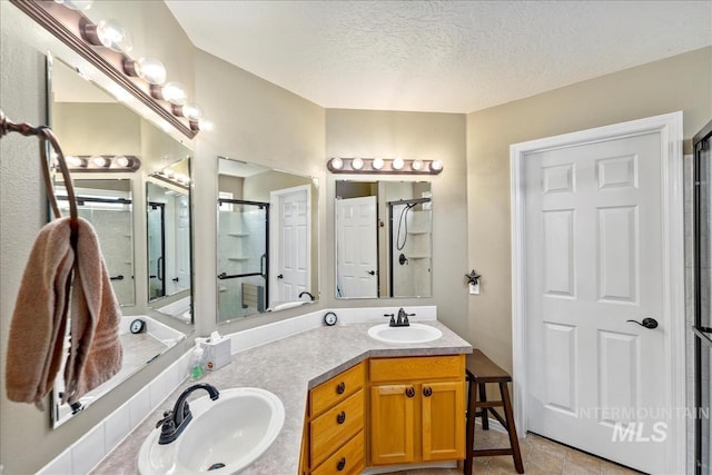 3804 Stonehedge Way, Caldwell, ID 83605 - full bath with double vanity, a textured ceiling, and an enclosed shower