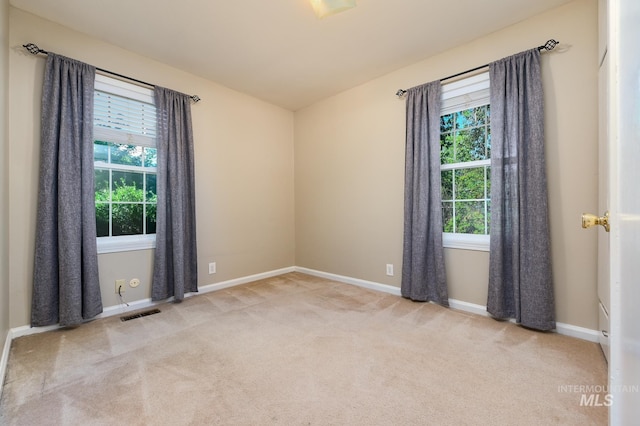 empty room featuring light carpet